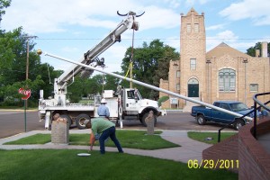 Crane lifting flagpole higher