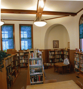 picture overlooking bookshelves in high-ceilinged room